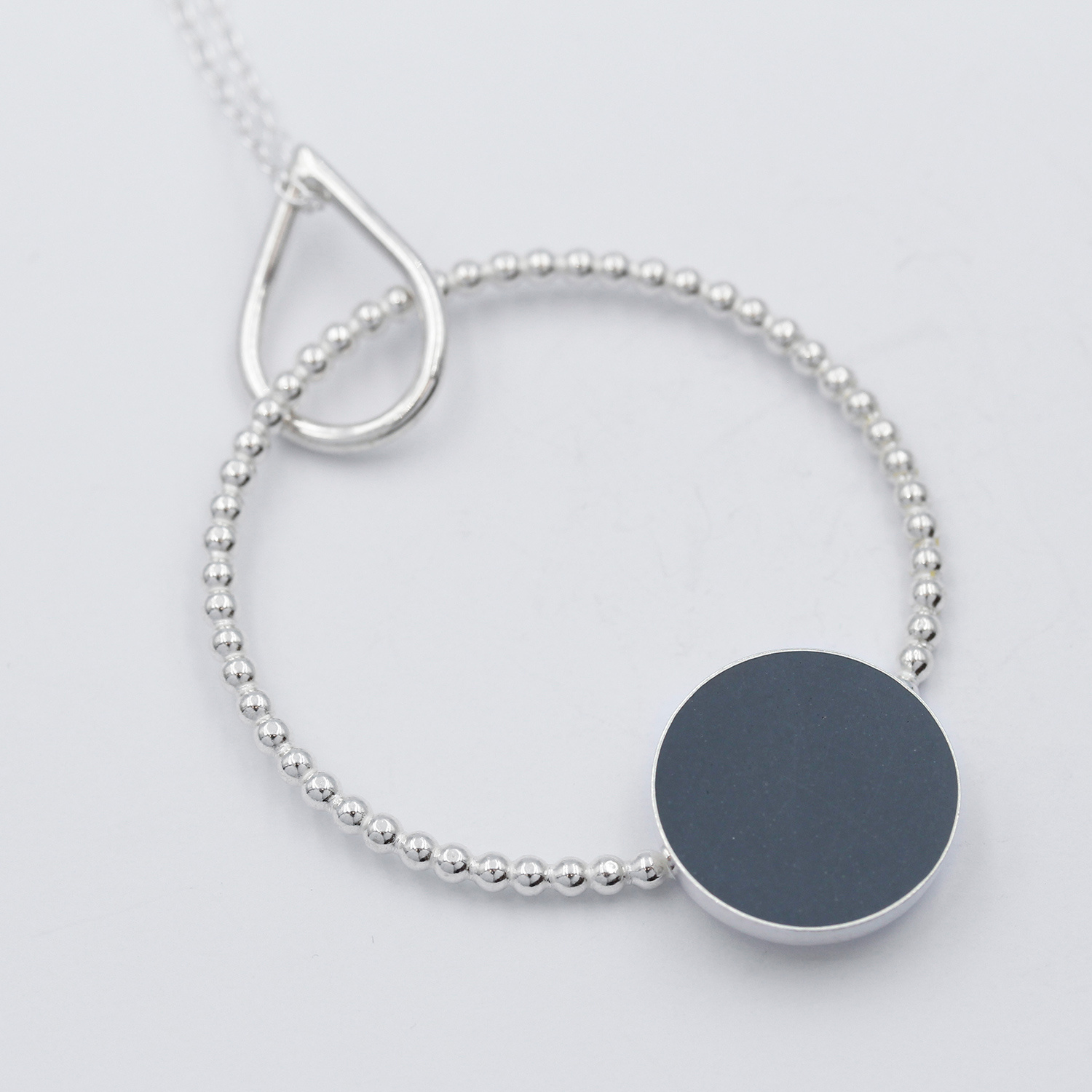 Pendant, dotty grey circle by Claire Lowe